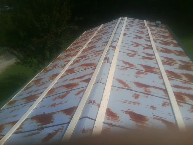 Rusted metal roof panels with new wood purlins before replacement — Storm Damage Roof Repair in Mesquite by Roofing Brothers